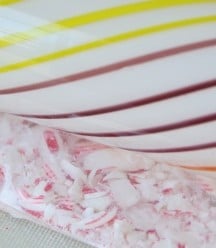 a bag of candy canes being crushed by a rolling pin