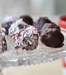 Vegan Raw Cookie Dough Balls on a glass plate. some dipped in chocolate and some in crushed candy cane
