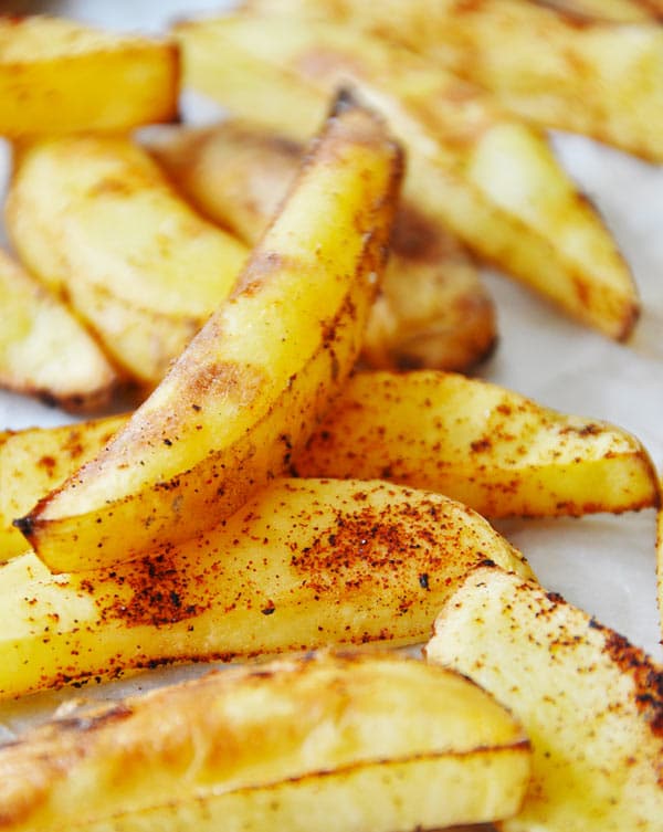 A pile of home fries with chipotle pepper and salt.