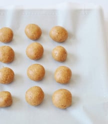 Peanut Butter balls on a piece of parchment paper.