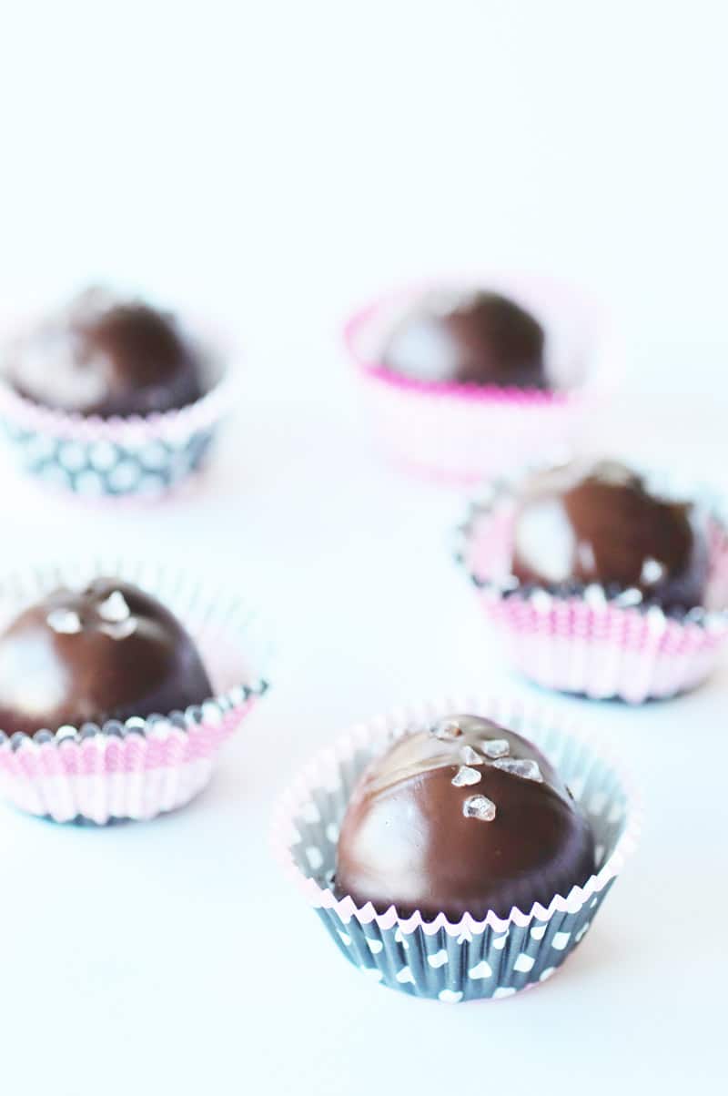 5 Ingredient Vegan Turtle Truffles (Raw & Gluten-free)in pink cupcake liners on a white background