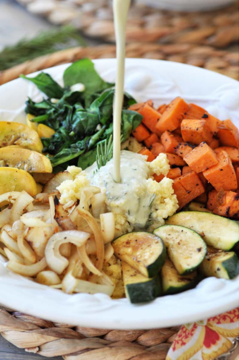 Summer Squash Buddha Bowl with Orange Ginger Dressing! This delicious and healthy Buddha bowl recipe is filled with superfoods and the most delicious creamy ginger orange dressing. It's a new family favorite. www.veganosity.com