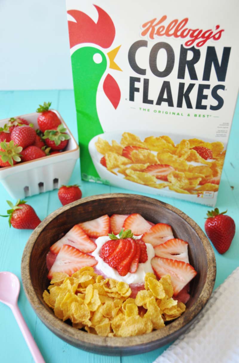 Vegan Strawberry Shortcake Smoothie Bowl! Make breakfast fun and lively with a healthy smoothie bowl made of strawberries, hemp seeds for energy, almond milk, coconut whipped cream, and Kellogg's Corn Flakes. Get the recipe at www.veganosity.com #ReimagineCereal #ad