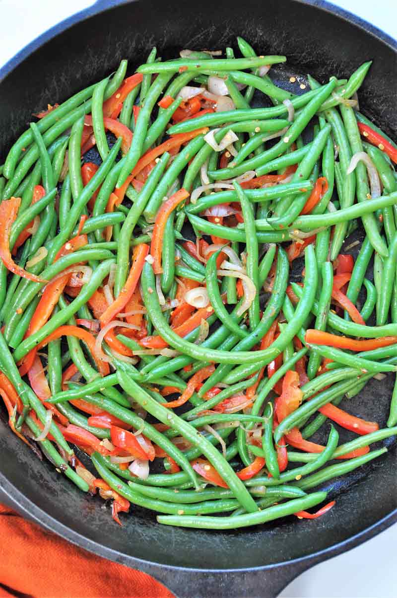 Spicy flash fried green beans, red peppers, and shallots! The perfect side dish recipe for the holidays! www.veganosity.com