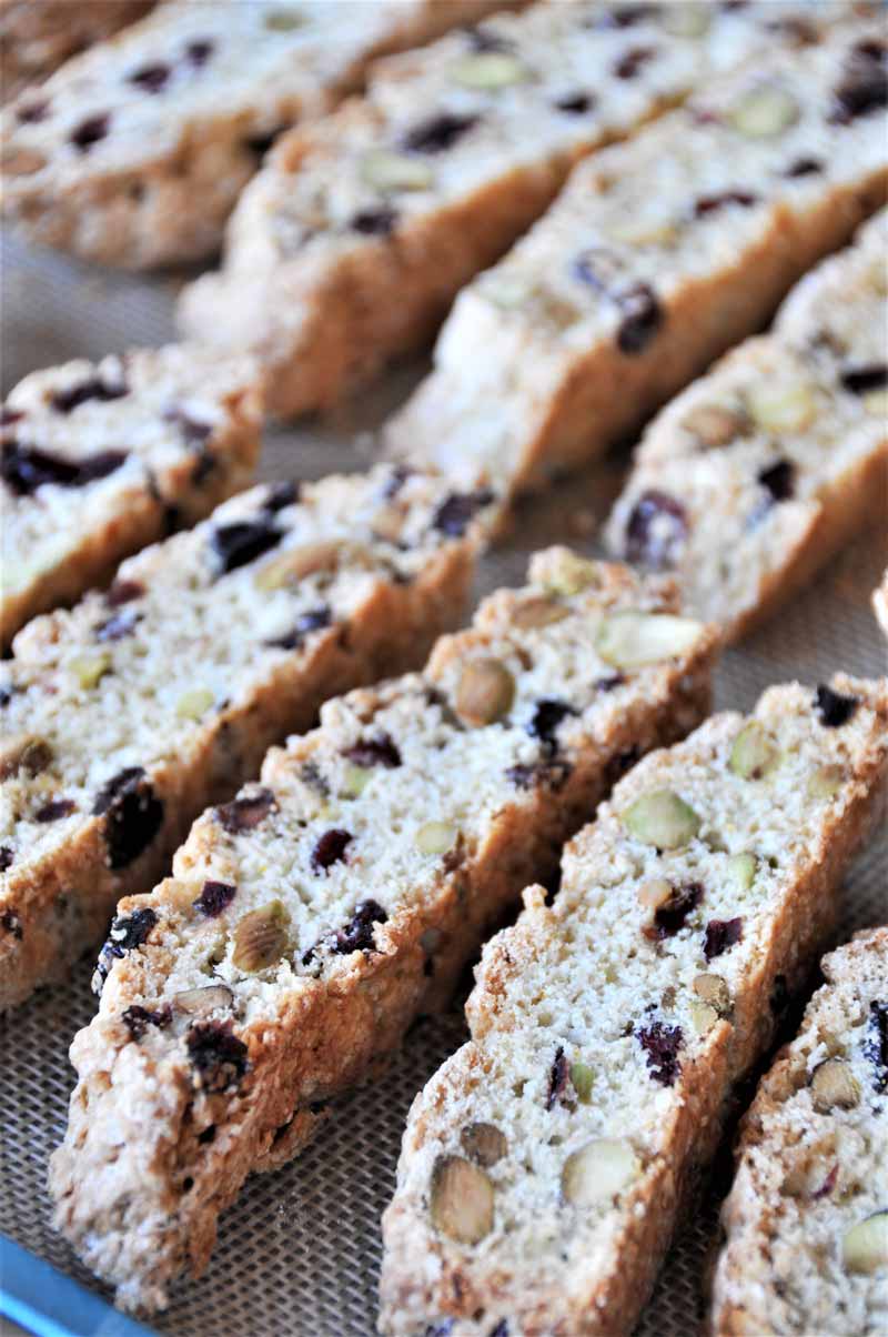 Cranberry biscotti cooling on a baking sheet.
