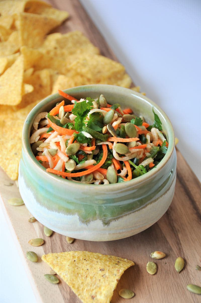 Jicama, carrots, Pablano pepper, in a refreshing lime dressing, topped with roasted pepitas! The perfect slaw salsa appetizer!