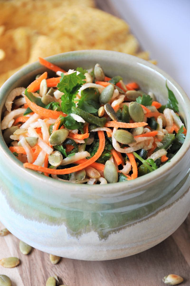 Jicama, carrots, Pablano pepper, in a refreshing lime dressing, topped with roasted pepitas! The perfect slaw salsa appetizer!