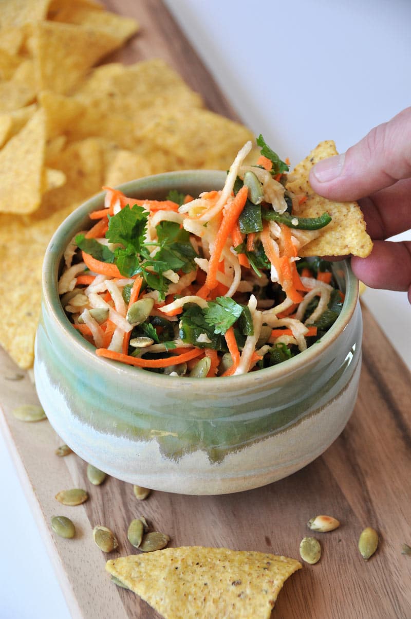 Jicama, carrots, Pablano pepper, in a refreshing lime dressing, topped with roasted pepitas! The perfect slaw salsa appetizer!