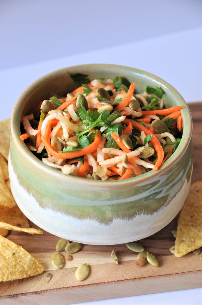 Jicama, carrots, Pablano pepper, in a refreshing lime dressing, topped with roasted pepitas! The perfect slaw salsa appetizer!