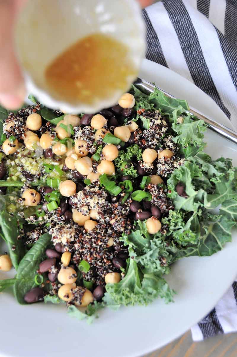 A protein packed superfood salad with black beans and chickpeas, kale and spinach. Healthy, delicious, and perfect for lunch or dinner.