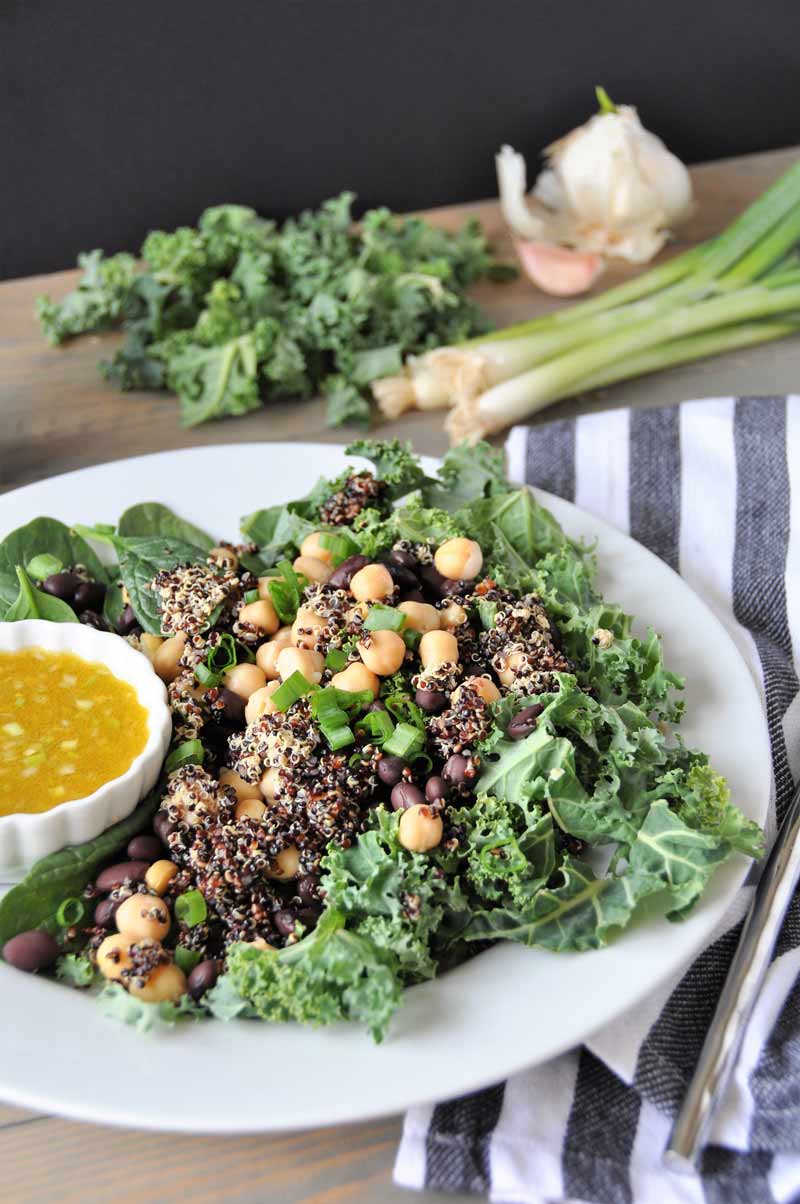 A protein packed superfood salad with black beans and chickpeas, kale and spinach. Healthy, delicious, and perfect for lunch or dinner. 