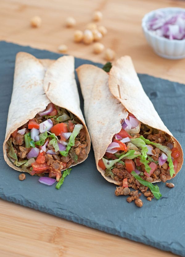 Two vegan Greek Burritos on a slate tray from Vegan Burgers and Burritos cookbook