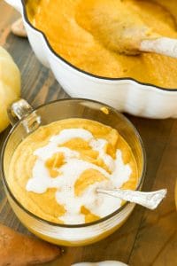 close up of hannah sweet potato and pumpkin bisque with cashew creme and white pumpkin next to it