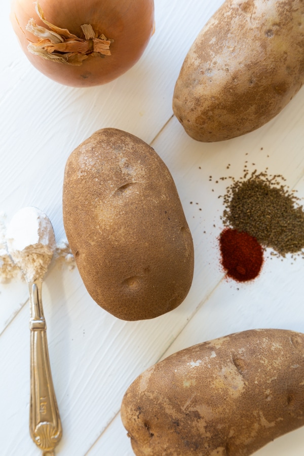 Potato pancake ingredients including potatoes, smoked paprika, celery seed, salt, flour, and pepper