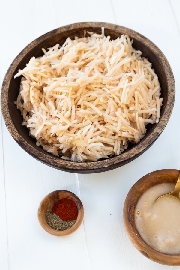 Spiced Potato pancake ingredients including shredded potato, spice blend, and vegan egg
