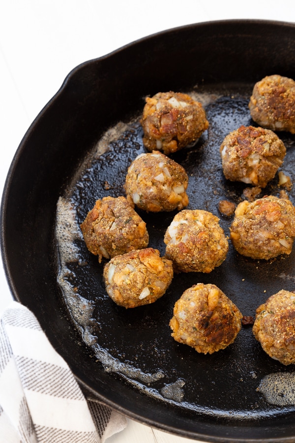 Vegan Swedish meatballs browned in vegan butter in a cast-iron skillet