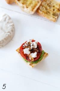 avocado spread with grilled tomato, vegan mozzarella, and fried shallots