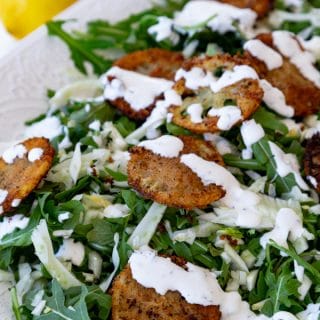 Delicious and delicate fried lemons in an arugula and fennel salad with a creamy lemon dressing! Totally vegan! #vegan #salad #friedlemons