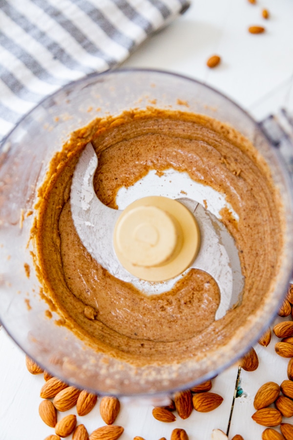 An overhead shot of almond butter in a food processor.