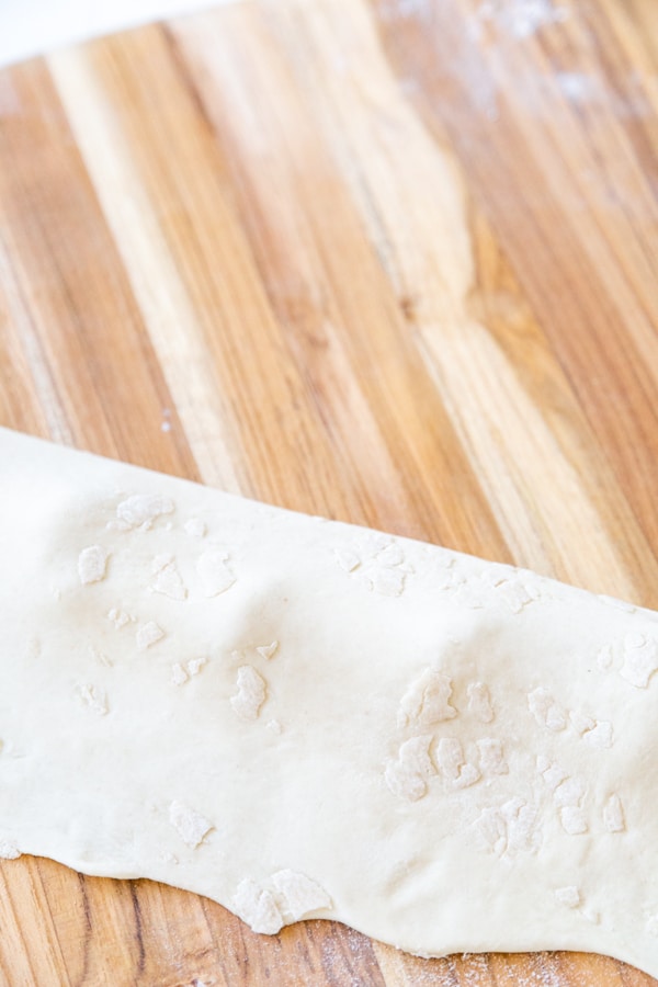 A sheet of pasta dough folded over pumpkin filling to make ravioli.