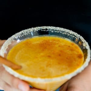 Hands holding a pumpkin spice martini.