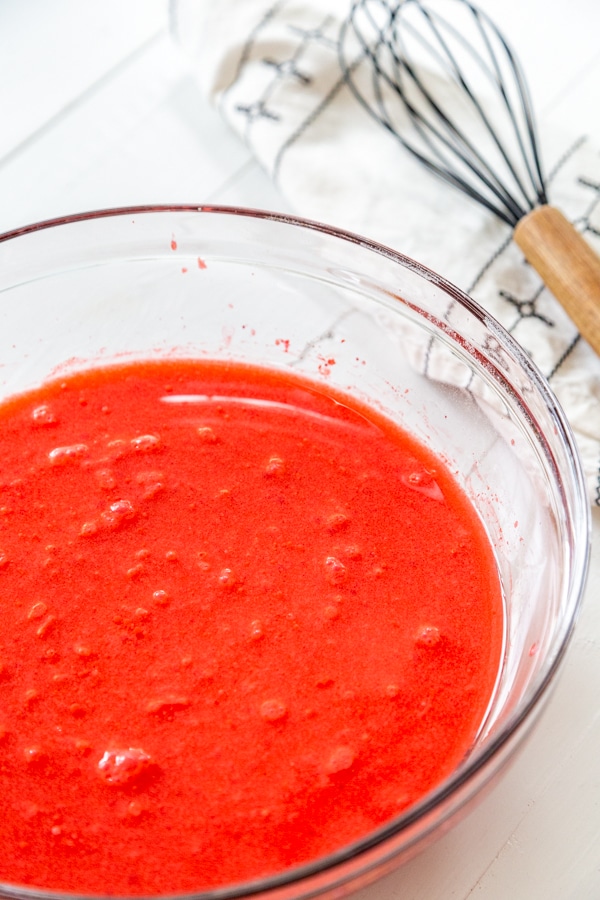 A glass bowl of red liquid.