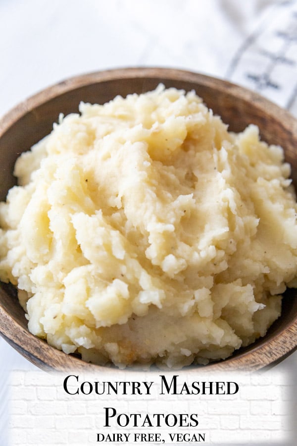 A Pinterest pin for mashed potatoes with a picture of the potatoes in a wooden bowl.