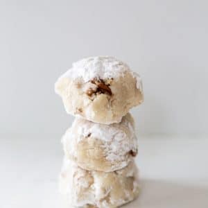 3 tea cake cookies stacked on top of each other on a white surface.