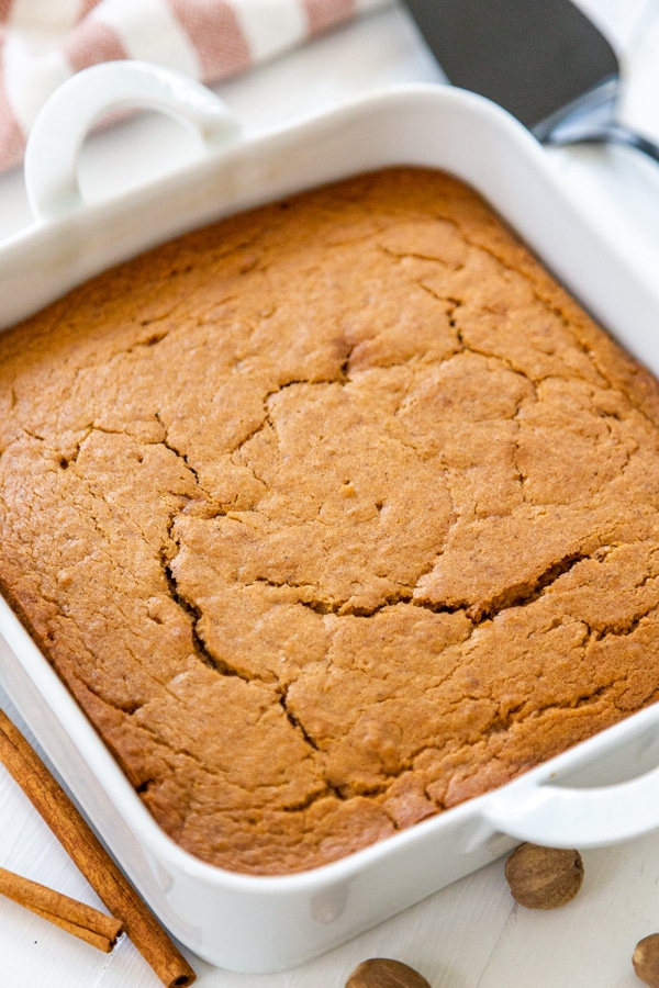 Spice cake in a square white cake pan.