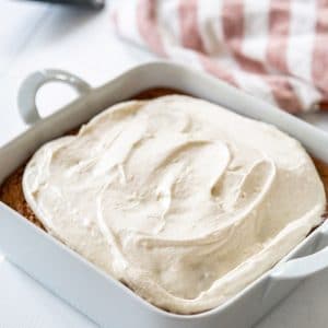 A Pinterest pin for spice cake with cream cheese frosting and a picture of the cake frosted in the pan.