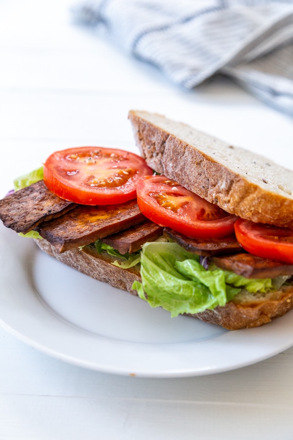 A BLT sandwich on a white plate. 