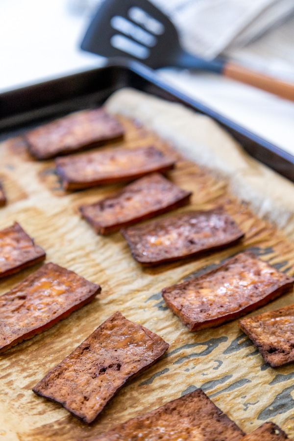 A baking sheet with tofu bacon.