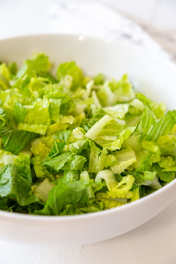 A large bowl of chopped lettuce.